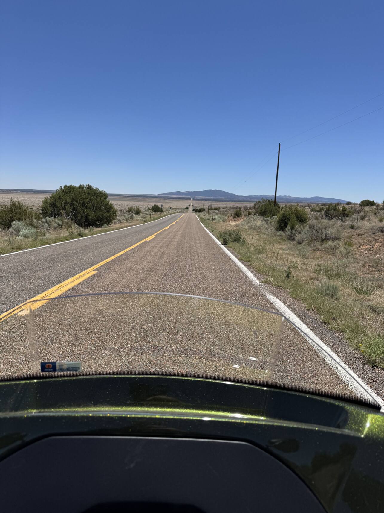 Open New Mexico highway seen over the trike's windshield